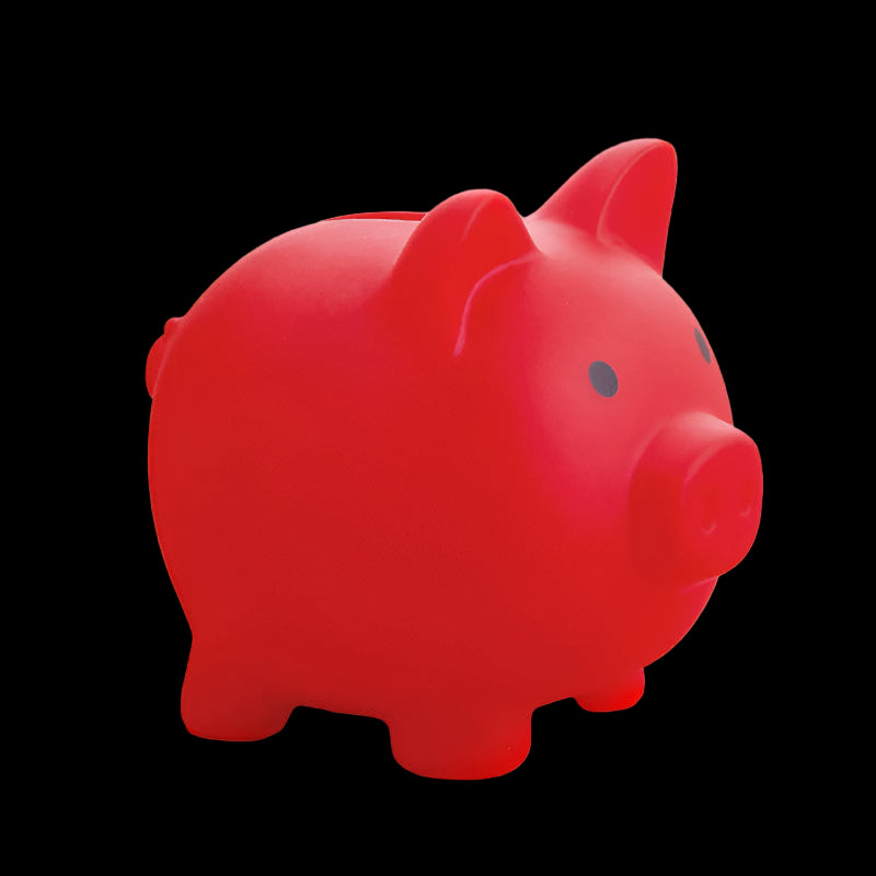 Red piggy bank on a pink surface