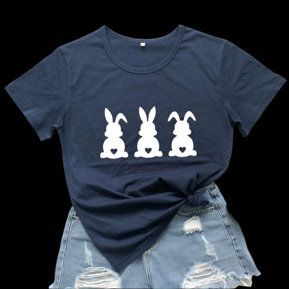 Navy blue t-shirt with white bunny design on a wooden surface with fruit and denim jeans.