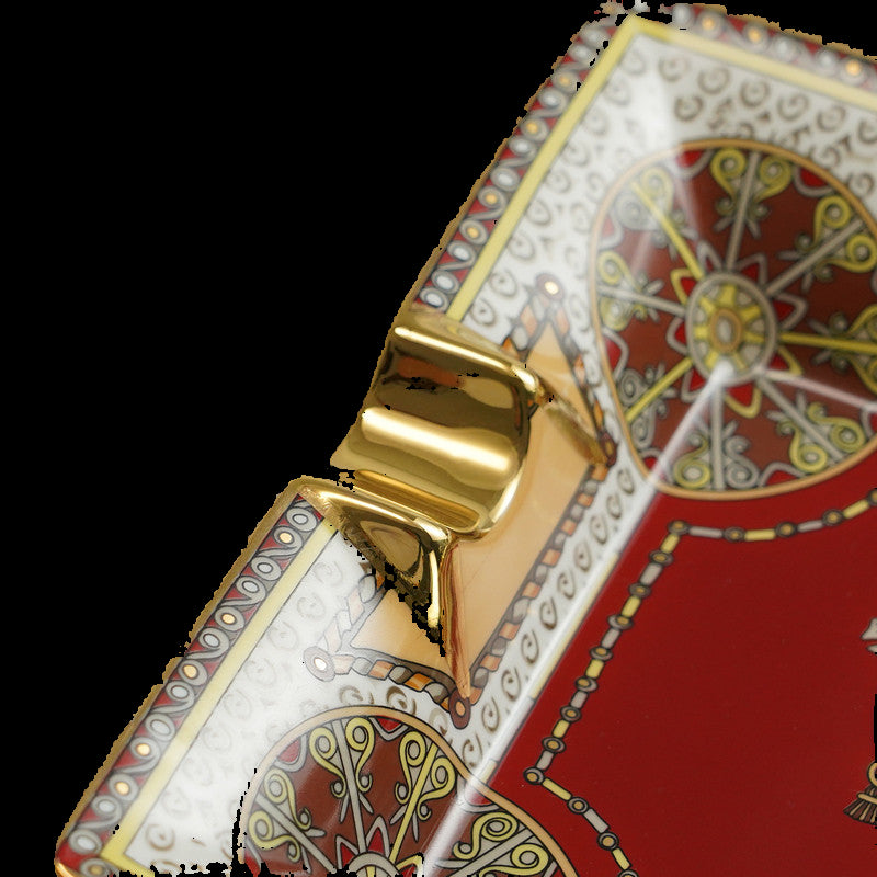 Decorative box with intricate patterns and a gold latch on a black background