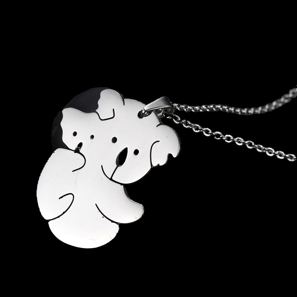 White koala pendant on a chain against a black background