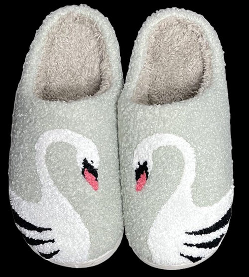 Pair of fuzzy slippers with swan design on a white background