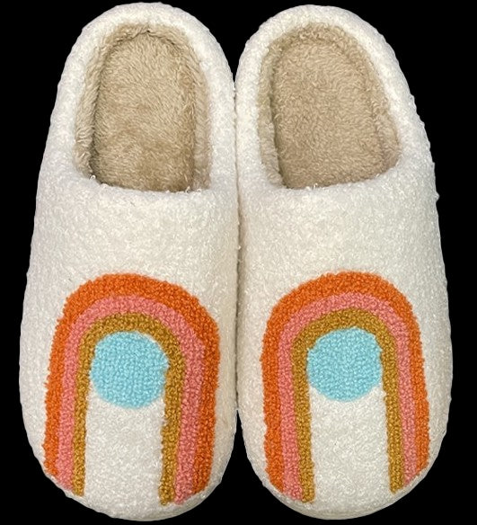 Pair of white slippers with rainbow design on a white background
