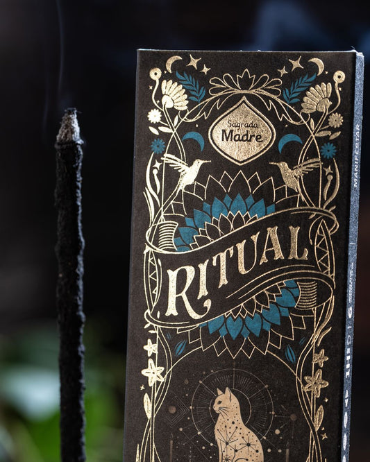 Decorative packaging with 'Ritual' branding and intricate designs on a dark background.