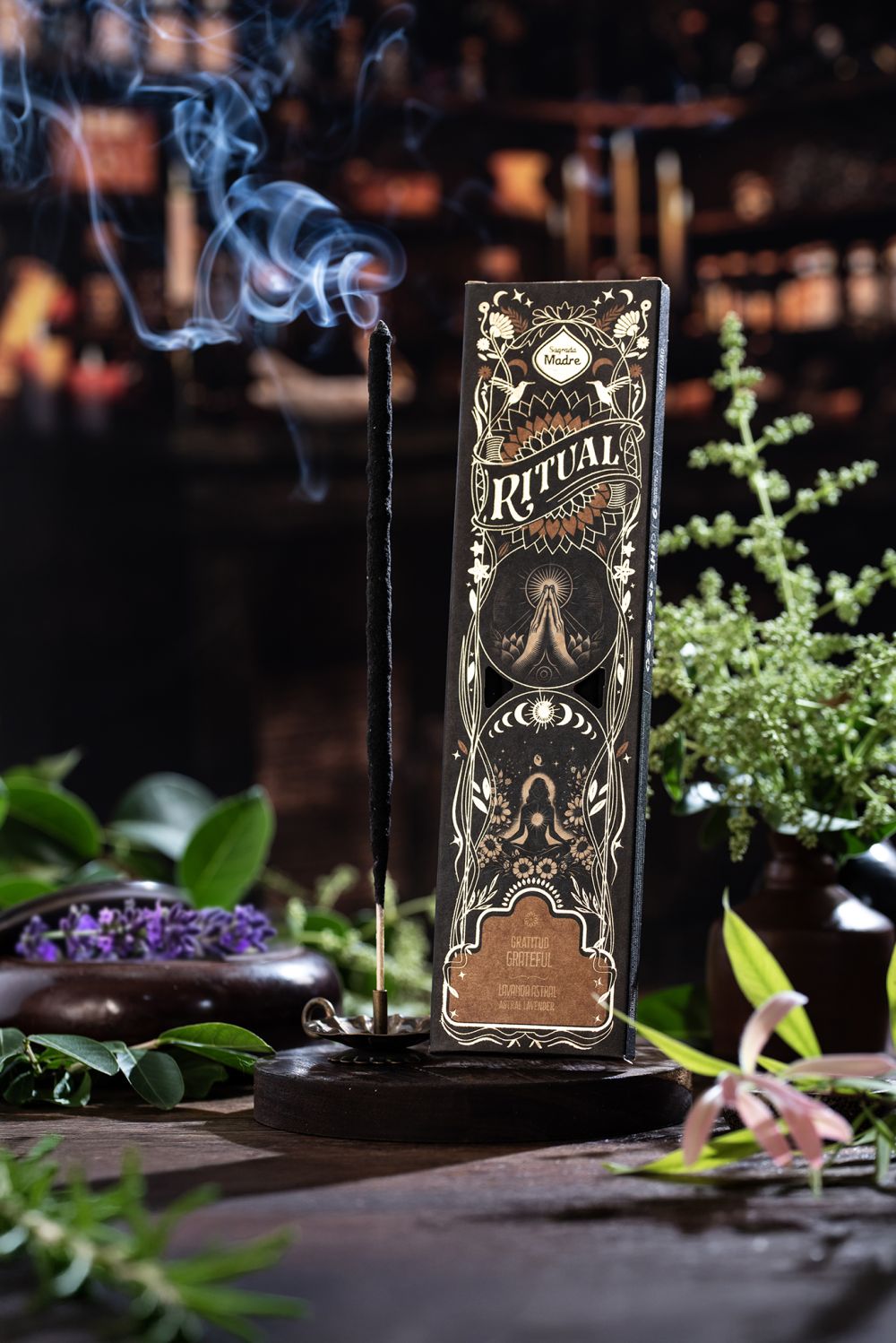 Ritual incense packaging with an incense stick on a dark background with plants.