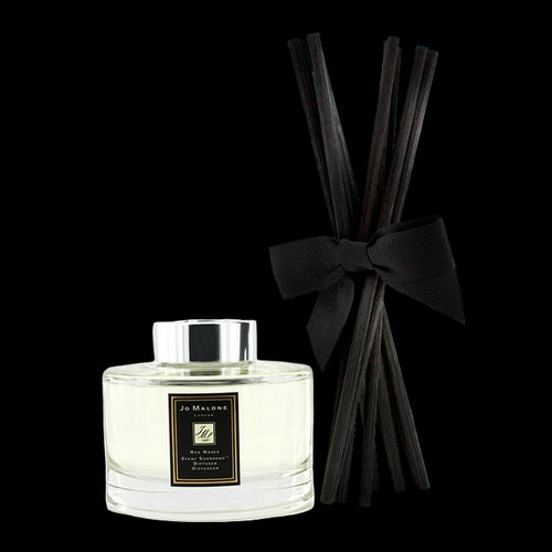 Jo Malone diffuser bottle with black reeds and bow on a white background