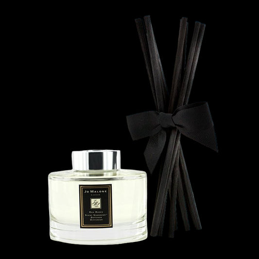 Jo Malone diffuser bottle with black reeds and bow on a white background