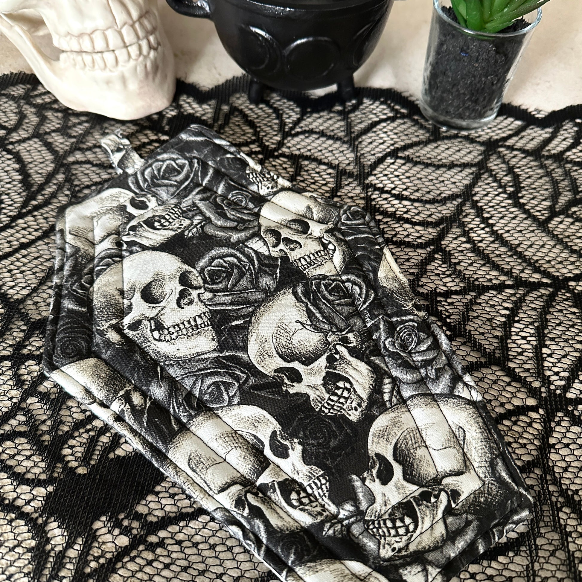 Phone case with skull and rose design on a black lace background