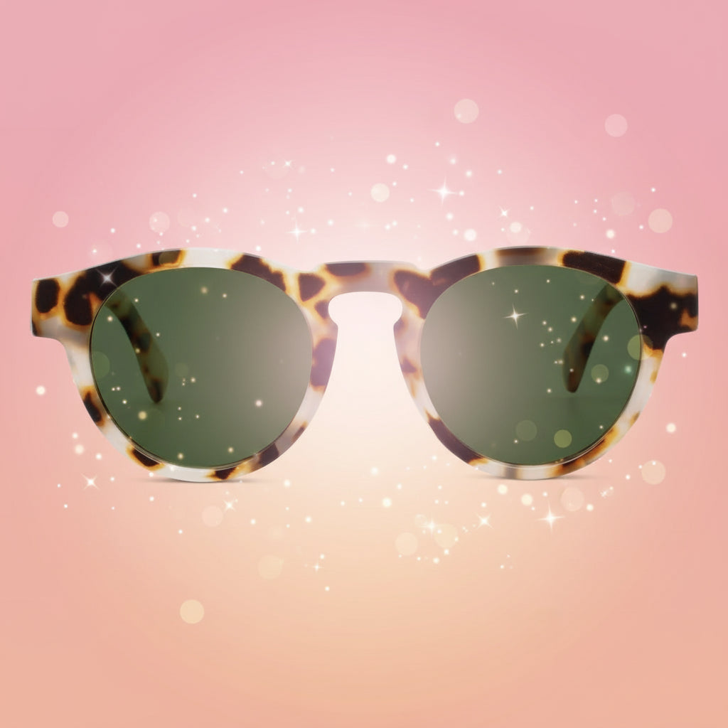 Sunglasses with tortoiseshell frame and green lenses on a white background