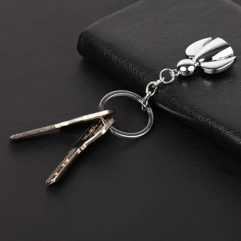 Silver keychain with a clip on a black surface