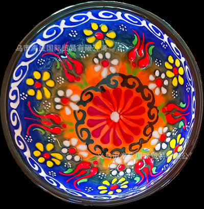 Decorative plate with colorful floral patterns on a textured surface
