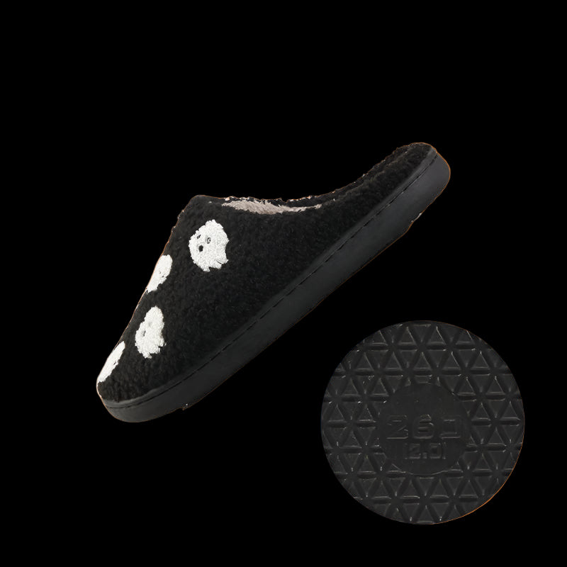 Black slipper with white paw prints on a white background