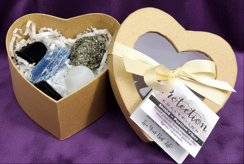 Heart-shaped box with crystals and a label on a white surface