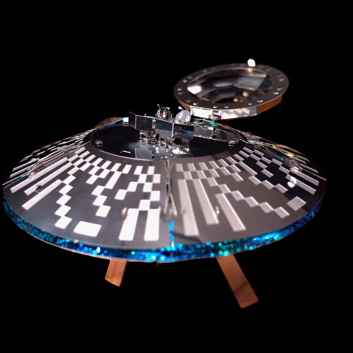 Model of a spaceship on a wooden surface with a blurred background