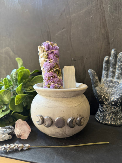 Decorative stone pestle and mortar with herbs on a dark surface