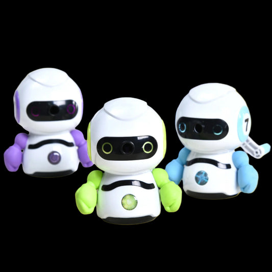 Three toy robots with different colored bodies on a light surface.
