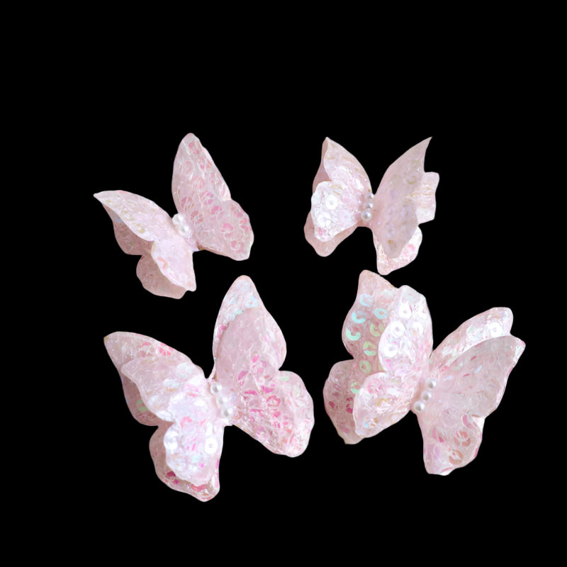 Pink butterfly-shaped candies on a textured beige surface