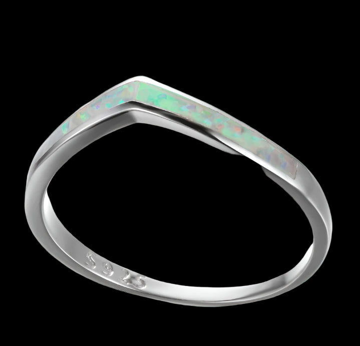 Silver ring with opal inlay on a white background
