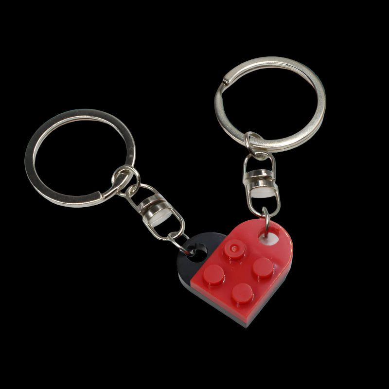 Heart-shaped keychain with LEGO design on a teal background