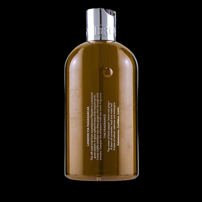 Brown bottle with silver cap on a white background