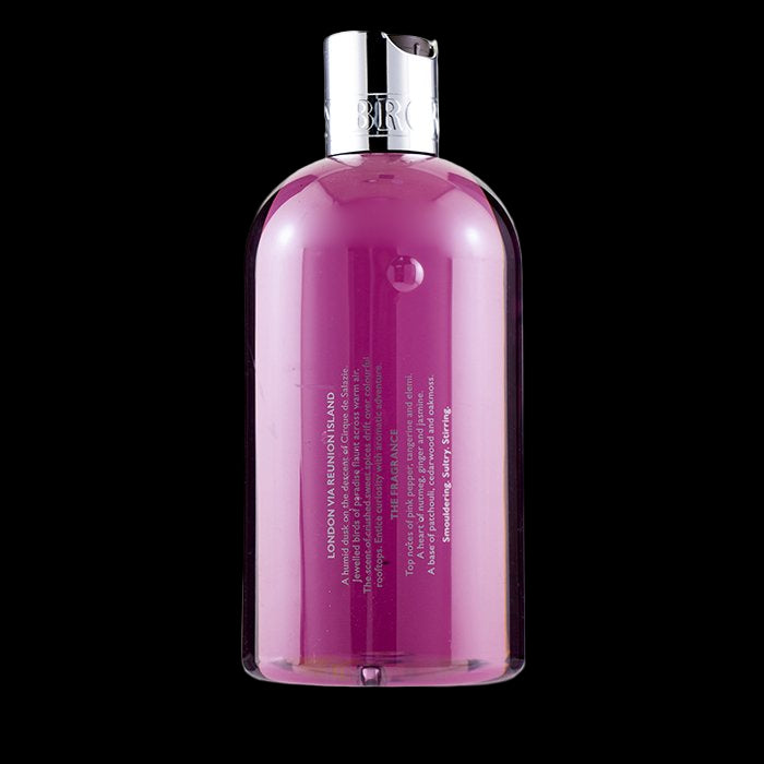 Pink bottle with silver cap on a white background