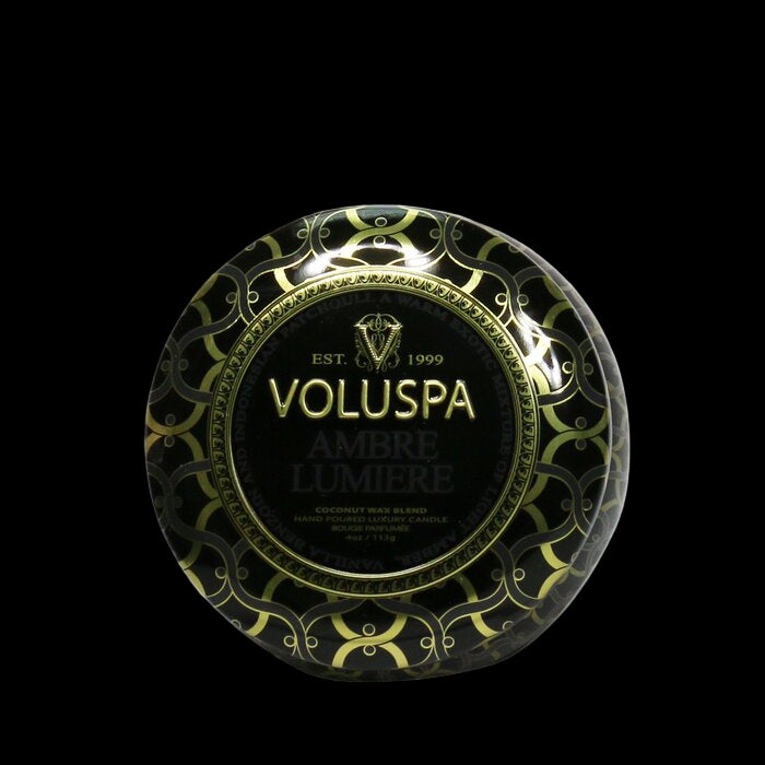 Voluspa Ambre Lumiere candle packaging with gold accents on a white background
