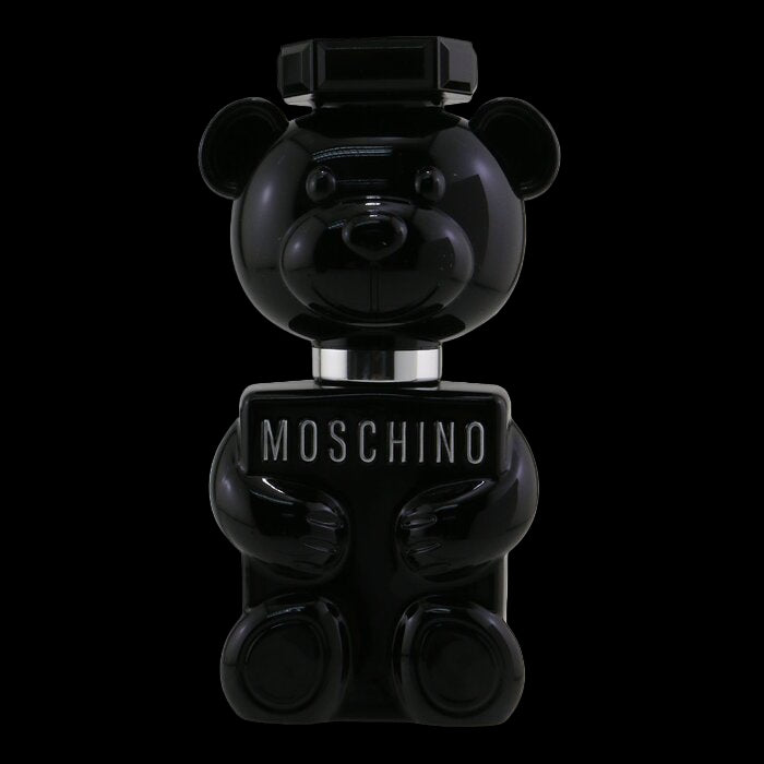 Black bear-shaped Moschino perfume bottle on a white background