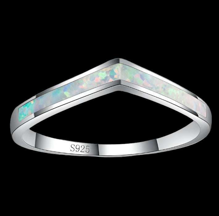 Silver ring with opal inlay on a white background