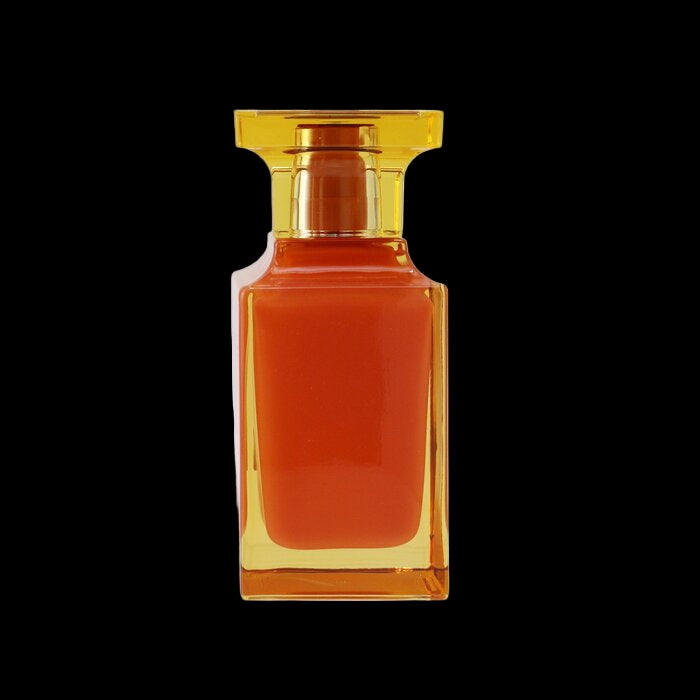 Amber-colored perfume bottle with gold cap on a white background