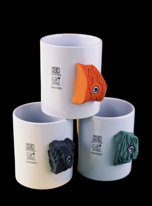 Three white mugs with colorful animal-shaped handles on a colorful background