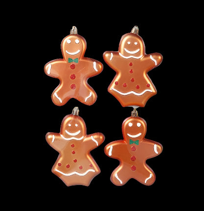 Four gingerbread man ornaments in clear packaging on a gray background