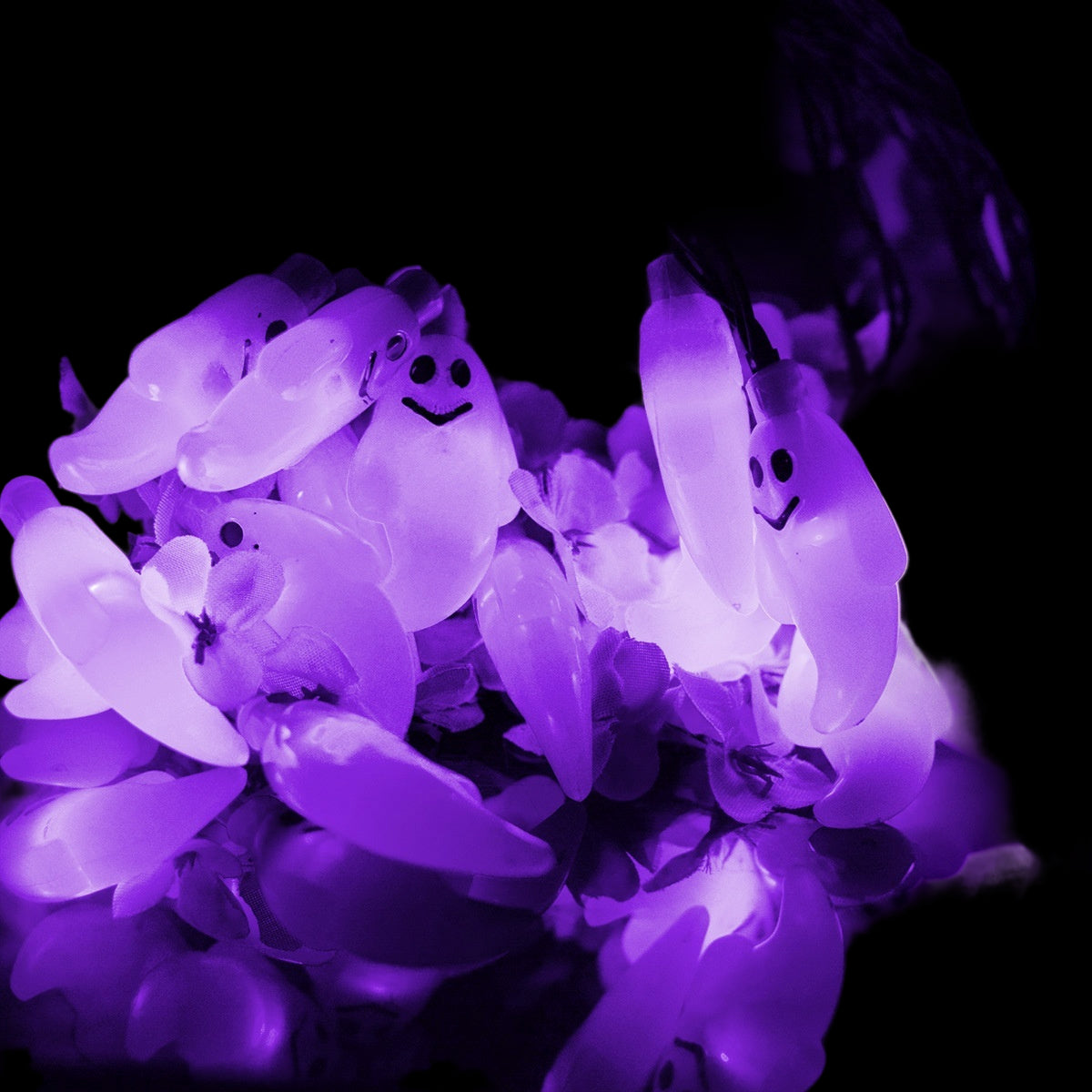 String of purple ghost lights on a dark background
