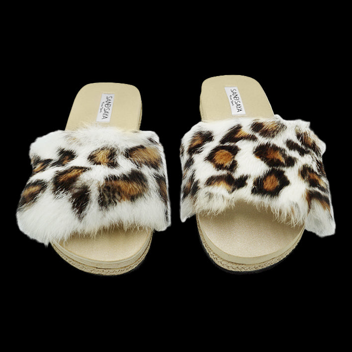 Pair of leopard print fur slides on a white background