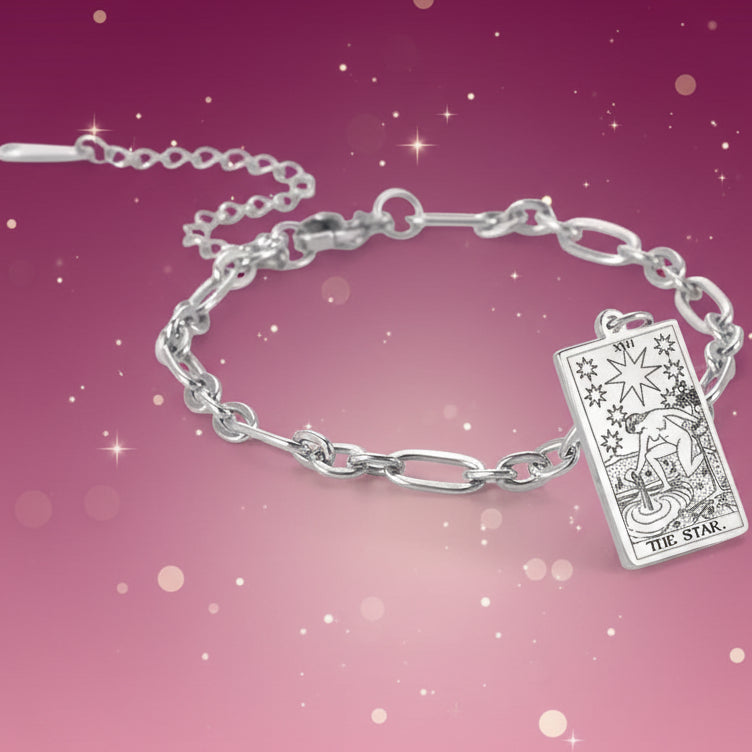 Silver bracelet with tarot card charm on a white background