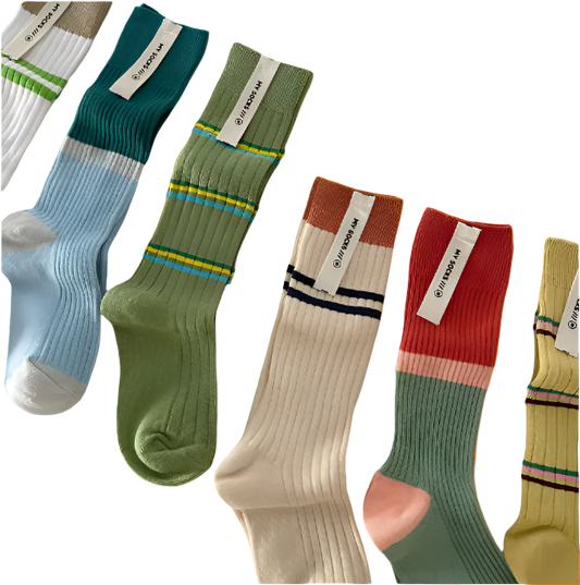 Set of colorful socks with striped patterns on a light gray background