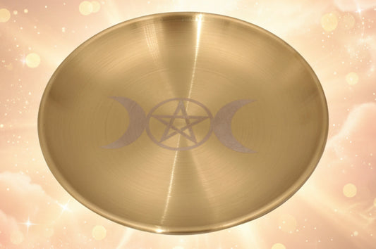 Gold plate with a pentacle and moon symbol on a white background