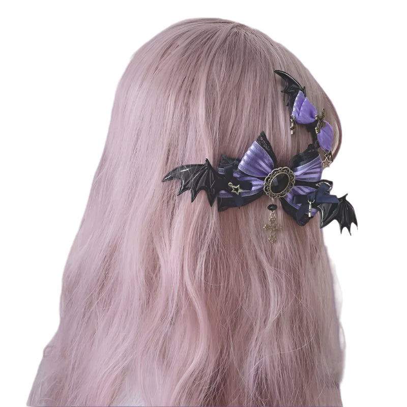 Hair accessory with purple bow and black bat wings on a person with pink hair against a floral background