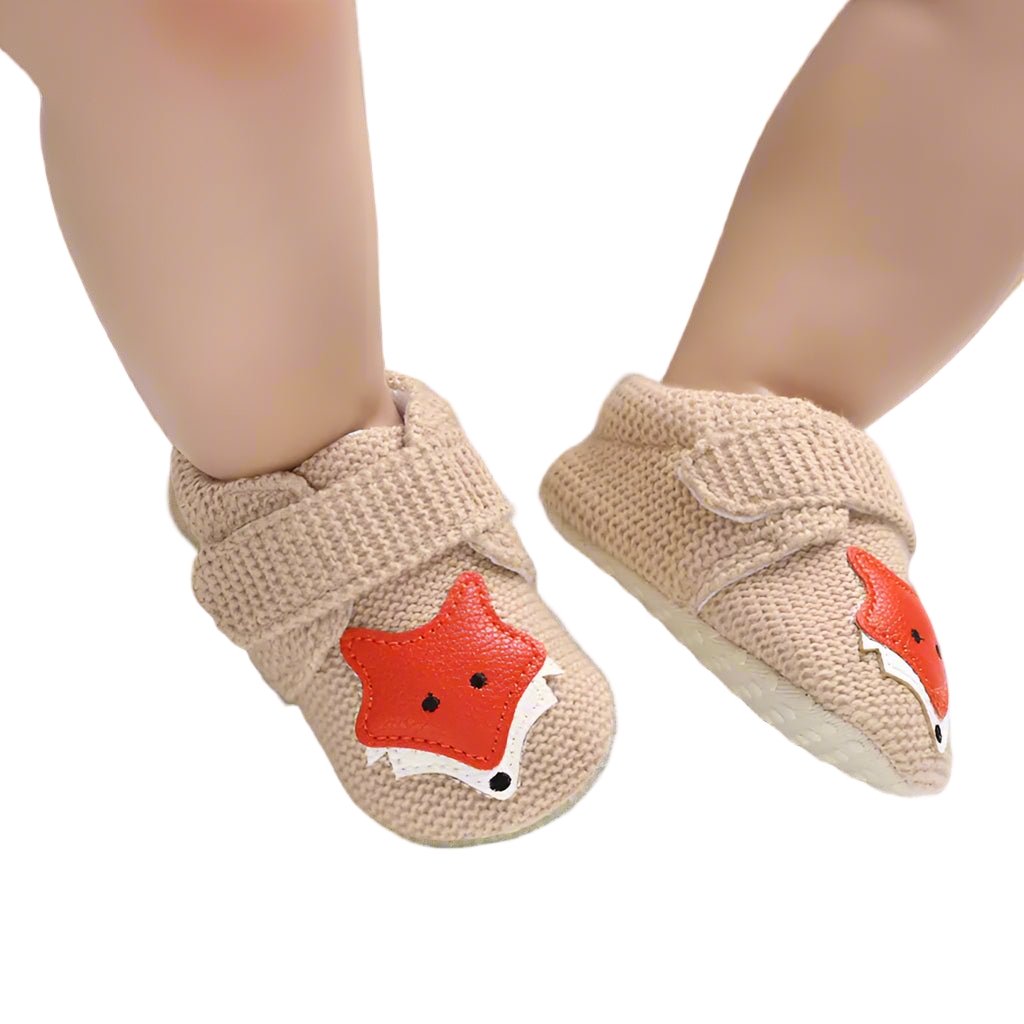 Baby shoes with fox design on a white background