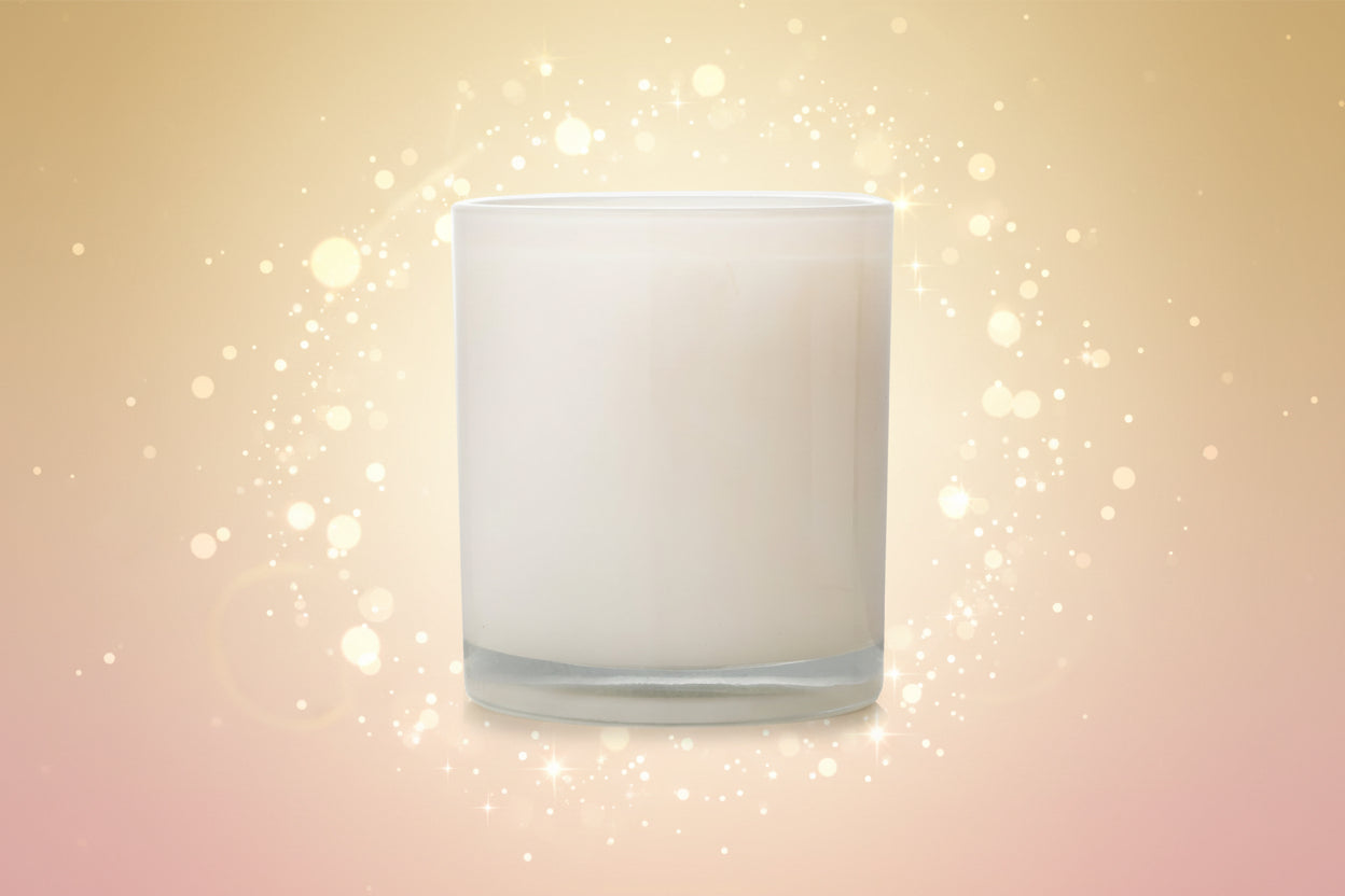 White candle in a glass holder on a white background