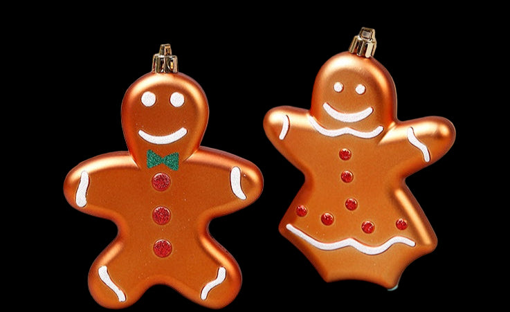 Two gingerbread man ornaments on a light gray background with Christmas decorations.