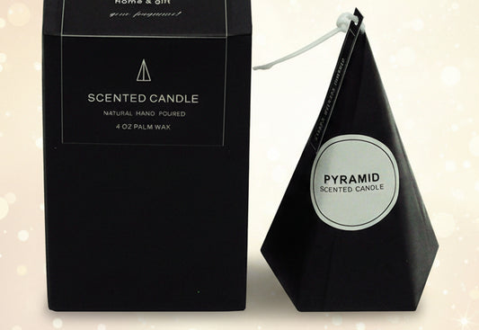 Pyramid-shaped scented candle with black packaging on a white background