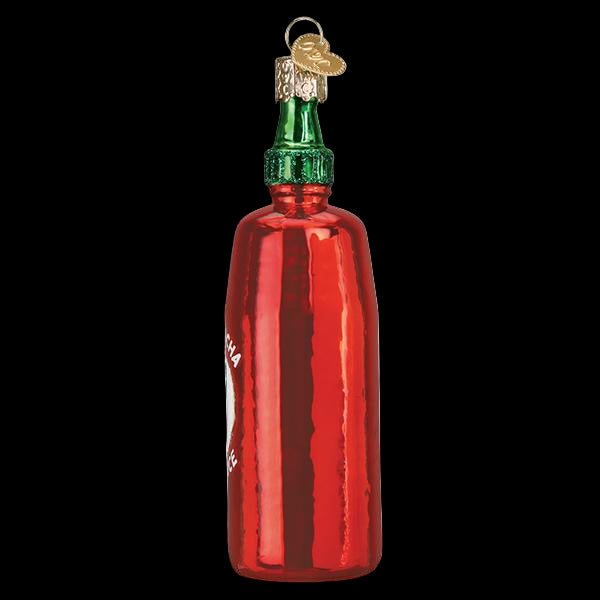 Red glass bottle ornament with green cap on a white background
