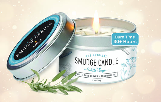 Smudge candle in a tin with white sage leaves on a white background