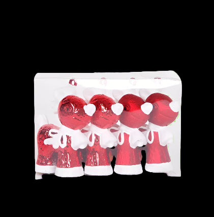 Set of red and white Christmas ornaments in clear packaging on a white background