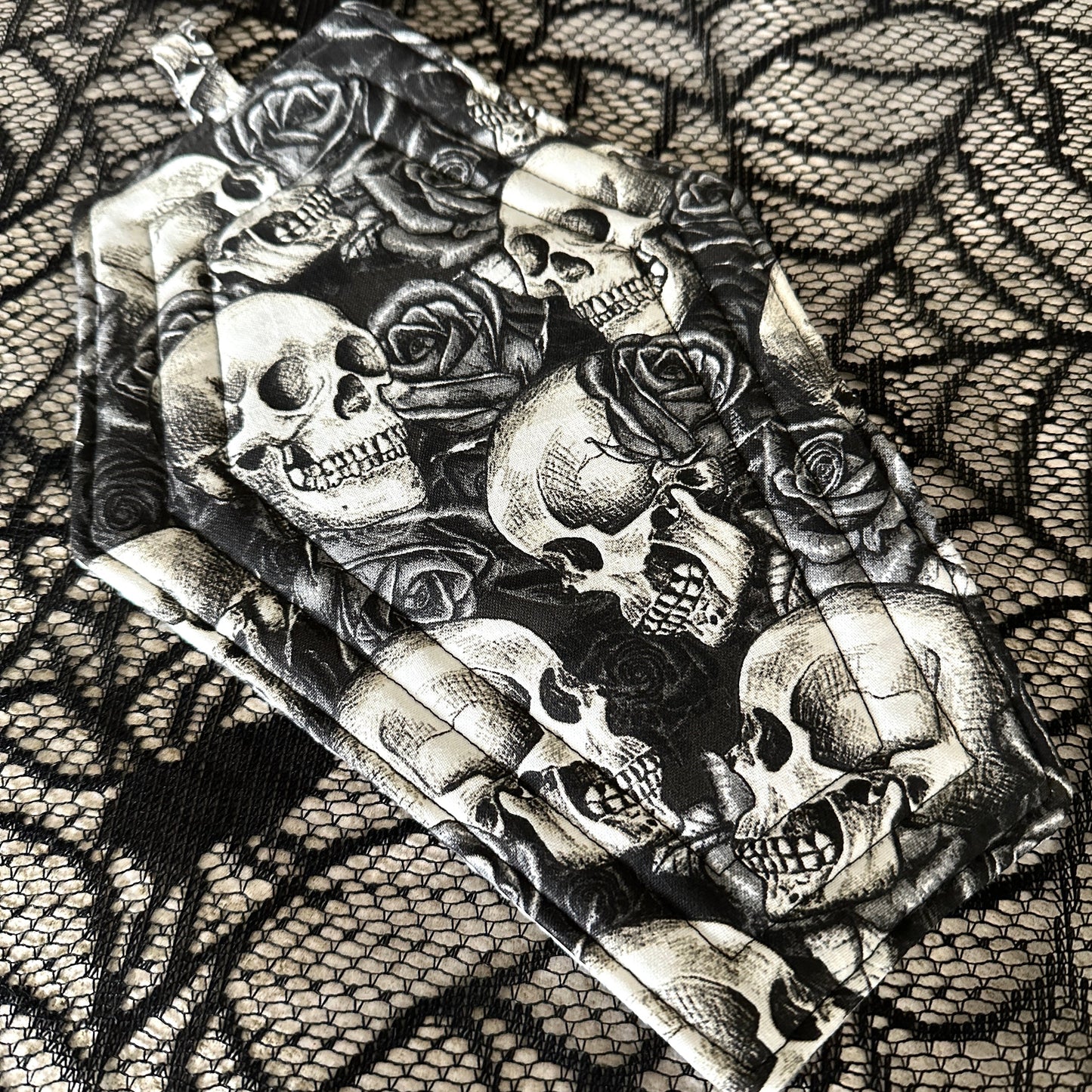 Artistic depiction of skulls and roses on a textured background