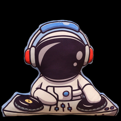 Cushion shaped like an astronaut sitting on a couch with a plant and wooden cabinet in the background.