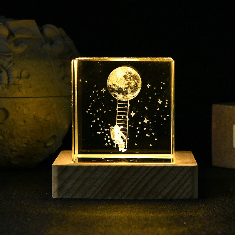 Decorative piece with a moon, stars, and ladder design on a dark background
