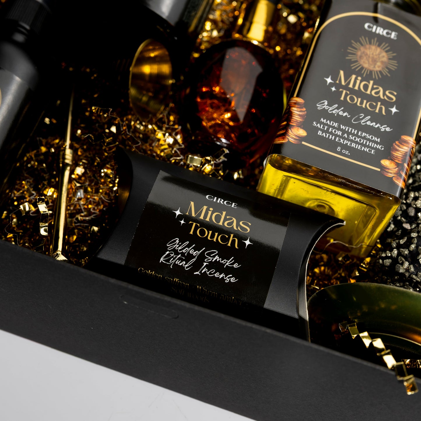 Bottle of Circe Midas Touch Golden Clear Gin with decorative elements on a dark background