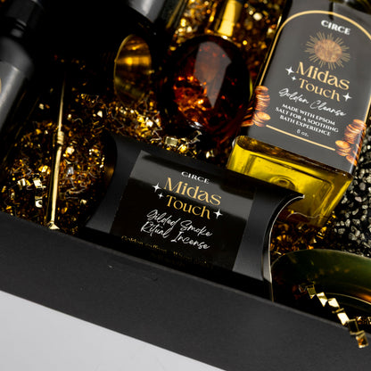 Bottle of Circe Midas Touch Golden Clear Gin with decorative elements on a dark background