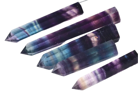 Set of multicolored crystal sticks on a white background