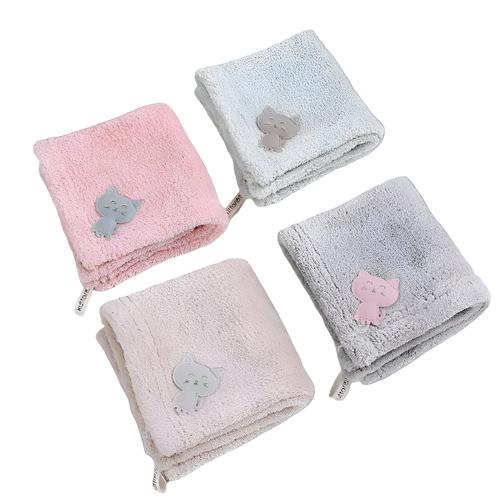 Four folded towels with cat appliqués on a white background